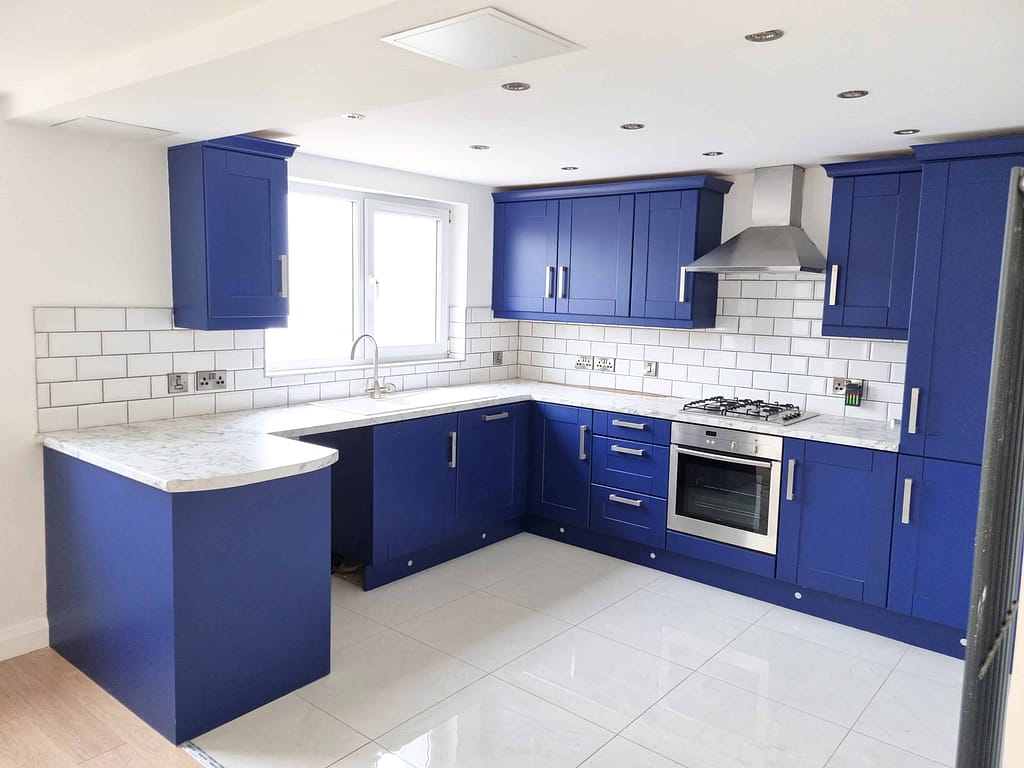 Modern kitchen with blue cabinets and tiles