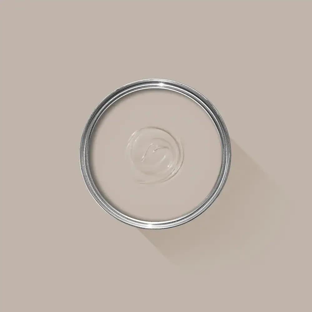 Shiny, clear paint can lid on a beige background, representing professional interior painting services in Portstewart. Perfect for illustrating expert painting and decorating by G&E Interior Painting.