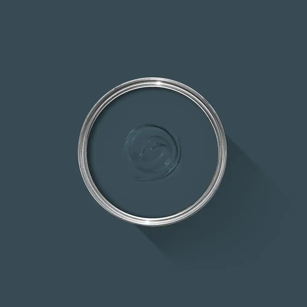 Clear glass round bowl on dark blue background, showcasing modern interior design and expert painting services in Portstewart.