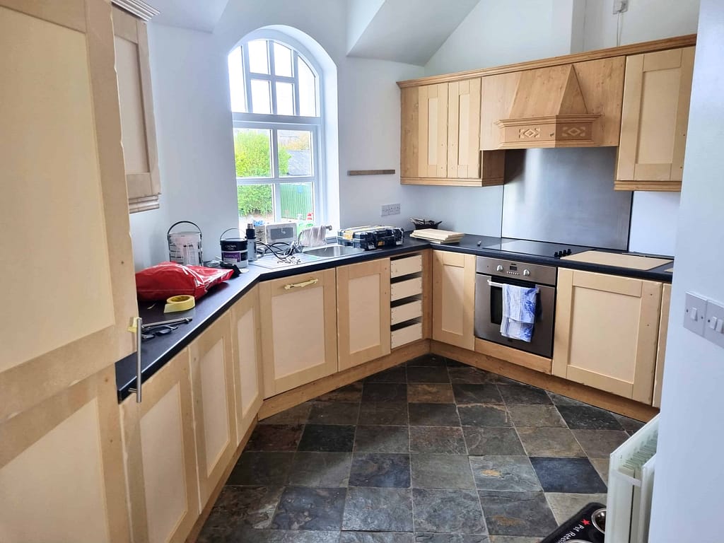 Outdated kitchen cupboards with worn finish