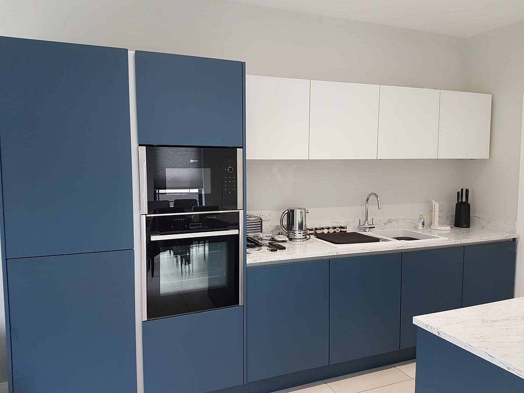 Bright blue and white modern kitchen cabinets featuring expert interior painting by G&E Interior Painting in Portstewart. Skilled painters enhance a contemporary home with professional finishing.
