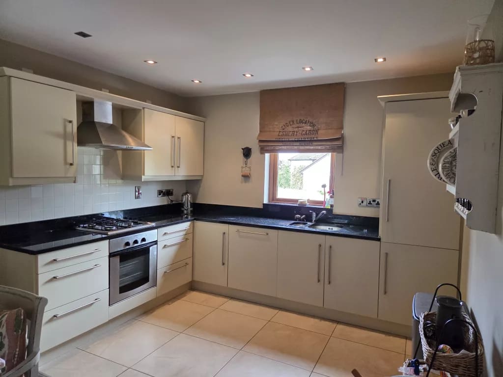 bright hand painted kitchen cupboards in Coleraine with smooth modern finish and light cream cabinets