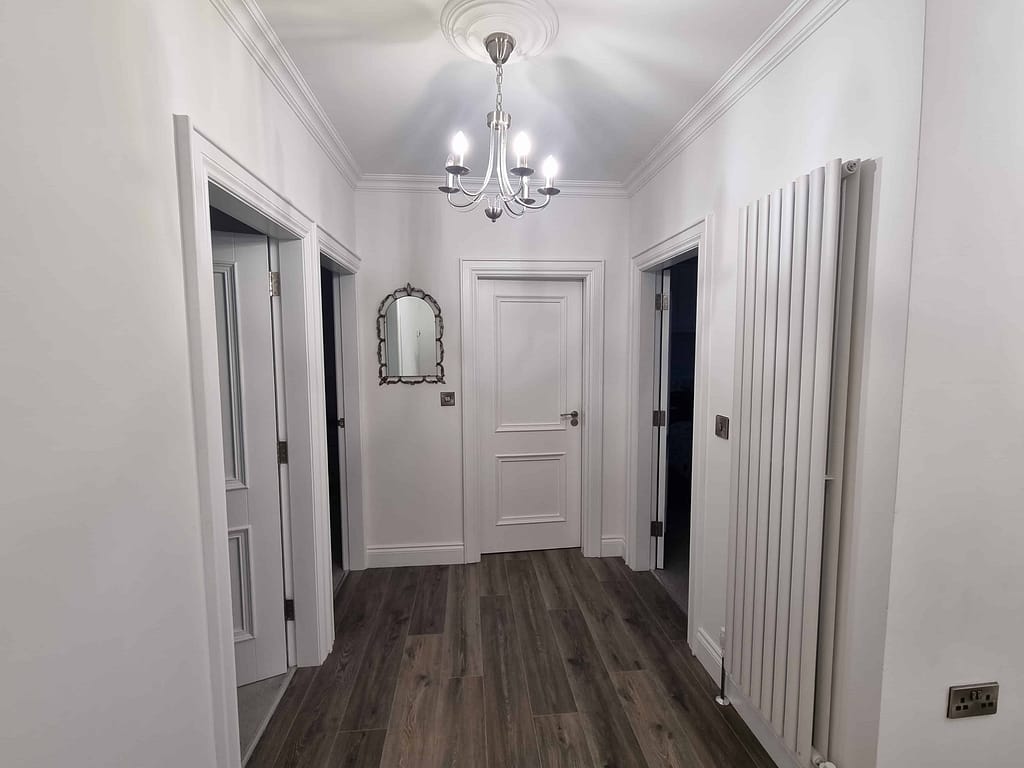 Bright white interior hallway painted by expert painters in Portstewart, showcasing professional wall and door finishes. Ideal for home interior painting and renovation projects.