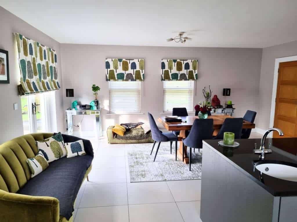Bright and modern interior living space with fresh painted walls, stylish window treatments, and contemporary furniture in Portstewart, showcasing expert interior painting by G&E Interior Painting.