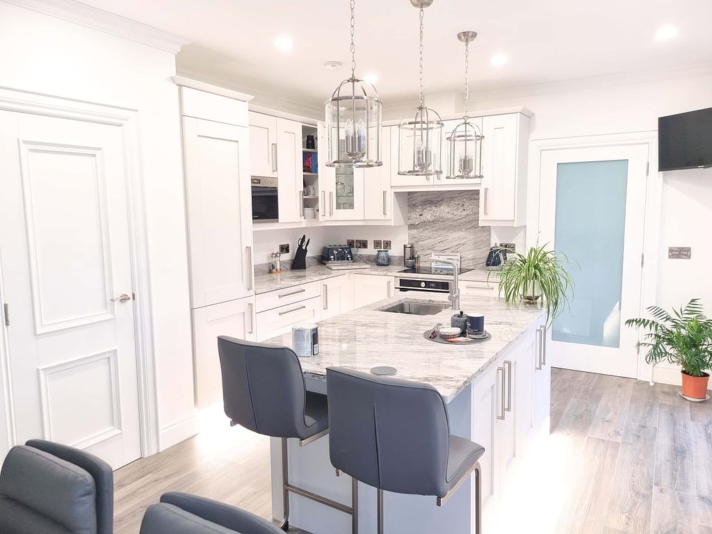 Modern kitchen with marble island and stools